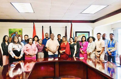 Minister of Home Affairs, Robeson Benn (centre) with Permanent Secretary Mr Andre Ally (at the rear) flanked by the graduates