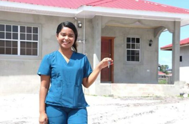 Dr. Leitisha Lynch holding the keys to her new home