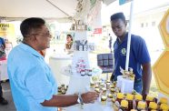 Agriculture Minister Zulfikar Mustapha with one of the participants at the event that displayed an array of honey types and products infused with honey, demonstrating the creativity and innovation within the sector