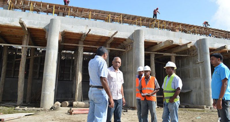 Agriculture Minister Dr Leslie Ramsammy inspects works on the eight -door high level sluice