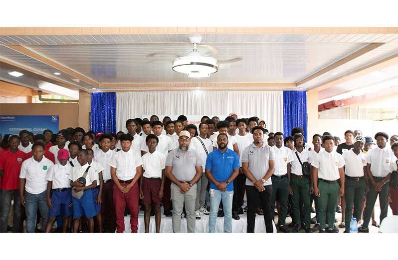 Community Relations Advisor for ExxonMobil Guyana, Ryan Hoppie (centre), along with the organisers and members of the competing schools
