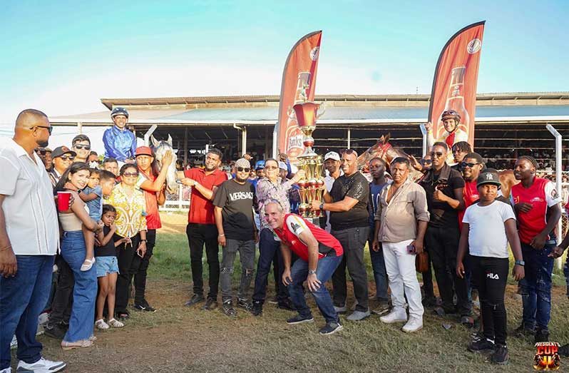 Horse-1 Winners! The winning connections of Dataman, President’s Cup 2025 winner collects the trophy from Outdoor Events Manager Mortimor Stewart yesterday. (Travis Montooth photos)