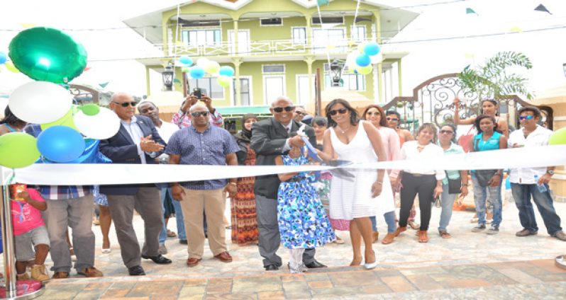 Ramcharan Boodhoo and his reputed wife, Rehana Rahim, assisting a girl in the symbolic ribbon-cutting exercise at the Palm Spring Hotel last Saturday in the presence of Natural Resources Minister Raphael Trotman