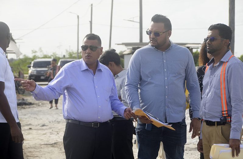 Housing and Water Minister, Collin Croal in discussion with Raj Persaud of Visionary Builders, one of contractors undertaking the construction project (Adrian Narine photo)