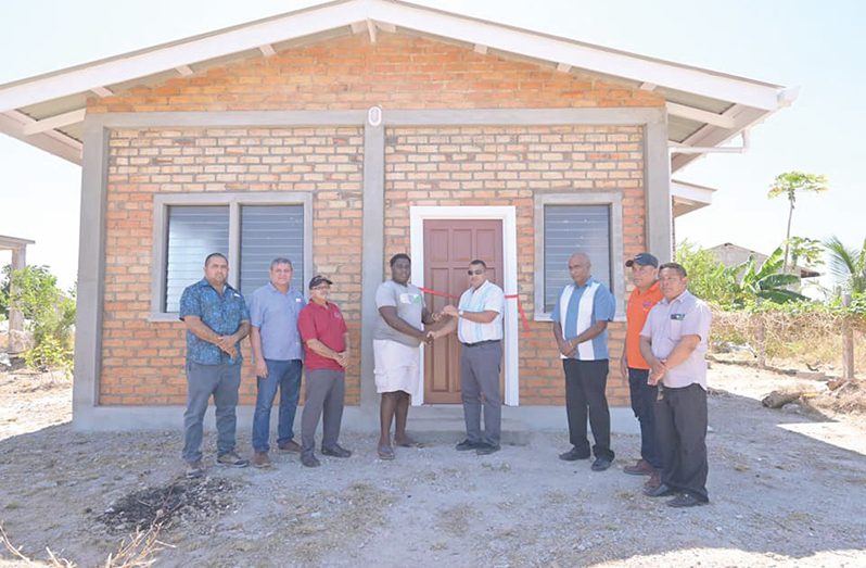 Minister of Housing and Water Collin Croal, joined by other officials, issued the beneficiaries their keys under the Lethem Housing Support Programme