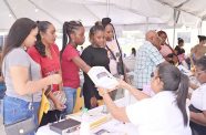 Allotees pull their lot numbers on Friday at the Ministry’s Regional Office in Pouderoyen, West Bank Demerara