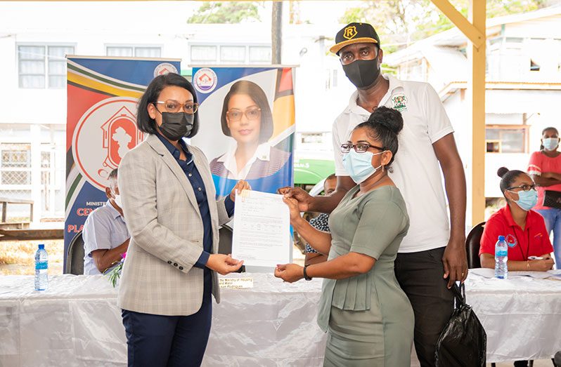 One of the low-income families in the Mahaica-Berbice region receiving their title from Minister within the Ministry of Housing and Water, Susan Rodrigues