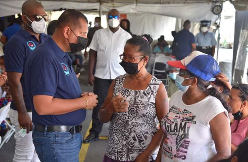 Minister of Housing and Water, Colin Croal, interacting with residents on the East Coast of Demerara
