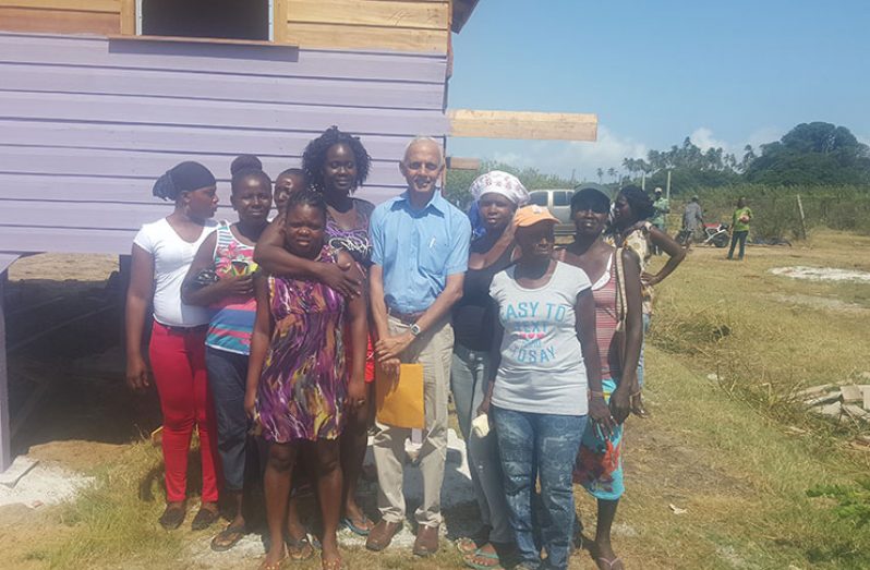 Minister of Communities Ronald Bulkan with some of the beneficiaries of the FFTP housing project.