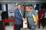 A Mabaruma resident pull a lot number from the envelope held by Minister of Housing and Water, Collin Croal as part of the government's ongoing national housing drive