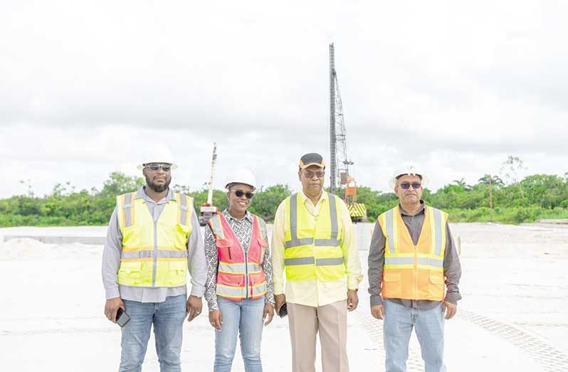 :  Minister of Public Works, Bishop Juan Edghill (second from right), the MOPW Project Manager for the Government Office Complex, Ms. Carissa Goodings, Aubrey Changlee, the team leader of VIKAB Guyana Inc (extreme right), and Mr. Chaman Basdeo, the Head of Operations at Caribbean Green Infrastructure Inc. at the construction site of the government complex at Houston, East Bank Demerara (Delano Williams photo)