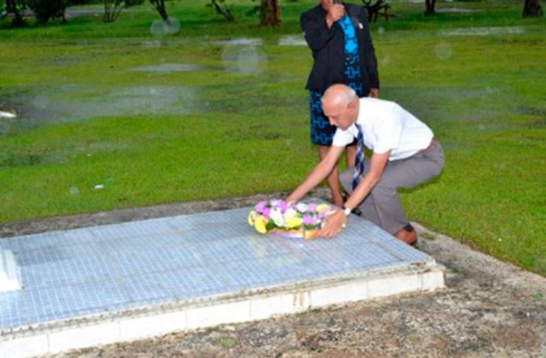 Minister of Communities, Ronald Bulkan, paying his respects to former President Hugh Desmond Hoyte.