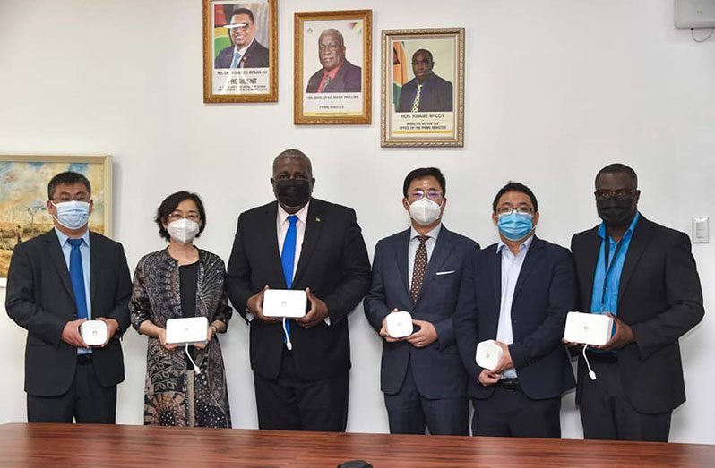 Prime Minister, Brigadier Mark Phillips (third from left) flanked by representatives of Chinese multinational technology corporation, Huawei and National Broadband Project-by- Project Manager, Rosco Greene (extreme right) (Office of the Prime Minister photo)