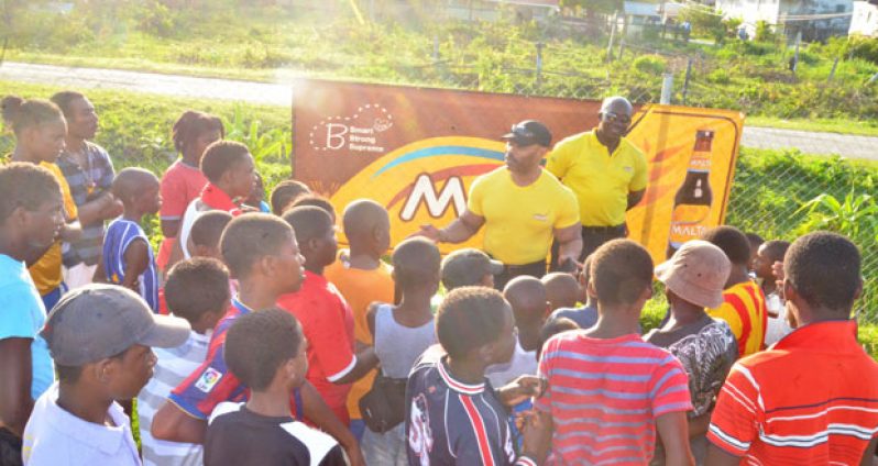 Hugh Ross and Clayton McKenzie interact with youths of Agricola during the Outreach exercise.