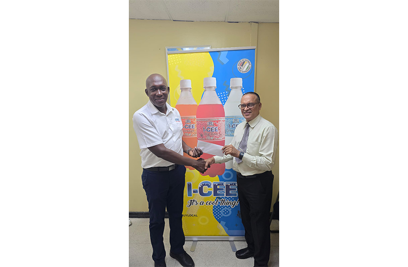 Brand Manager I-CEE Soft Drinks Mr. Clayton McKenzie, presents cheque for I-CEE Chess Grand Prix 2 to GCF Public Relations Director, Mr. Shiv Nandalall at Thirst Park, Georgetown.