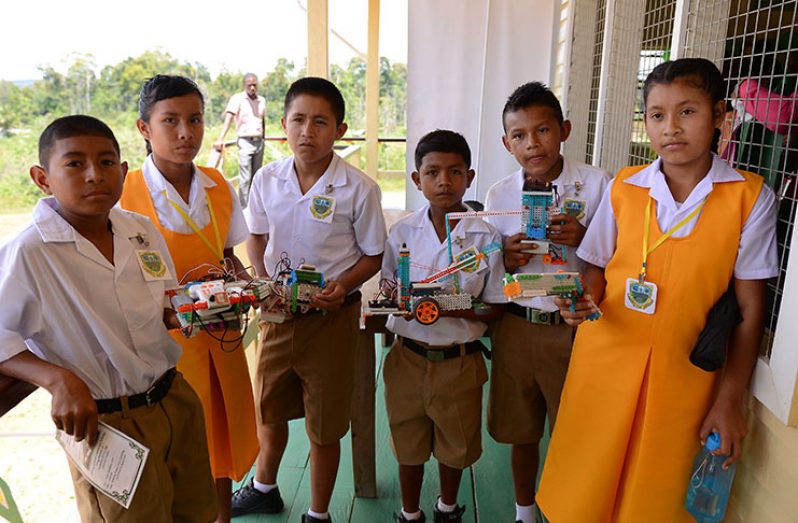 Students of the D.C Caesar Fox Secondary School with some of the robots they would have built – Delano Williams Photo.