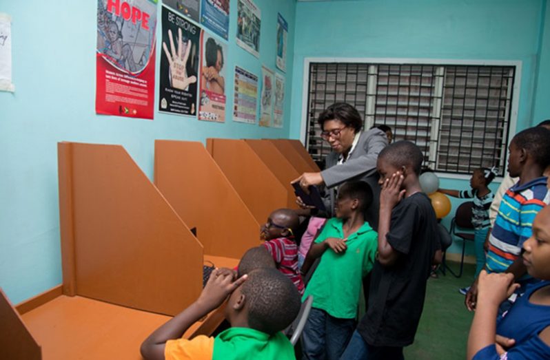 Minister of Public Telecommunications, Catherine Hughes interacts with some of the children who will frequently use the ICT Hub