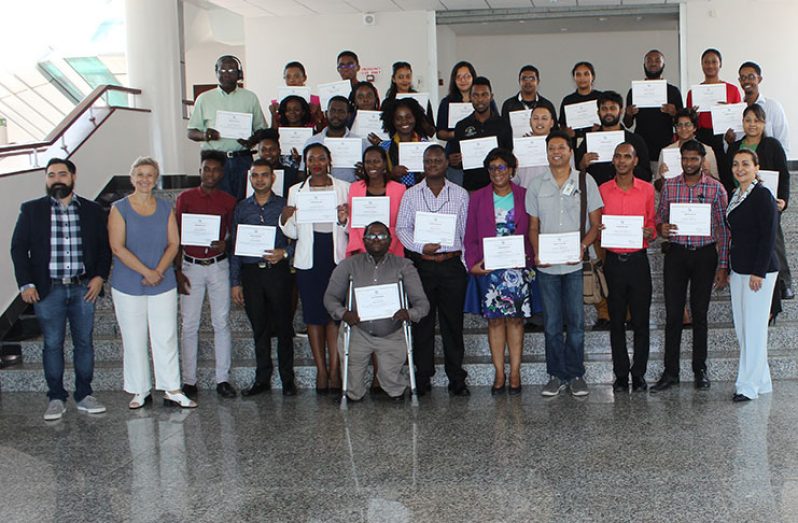 Minister Cathy Hughes, MoPT’s Web Services Coordinator, Jaime Skeete, and Roxana Widmer-Ilescu, ITU Senior Programme Officer, alongside the trainers