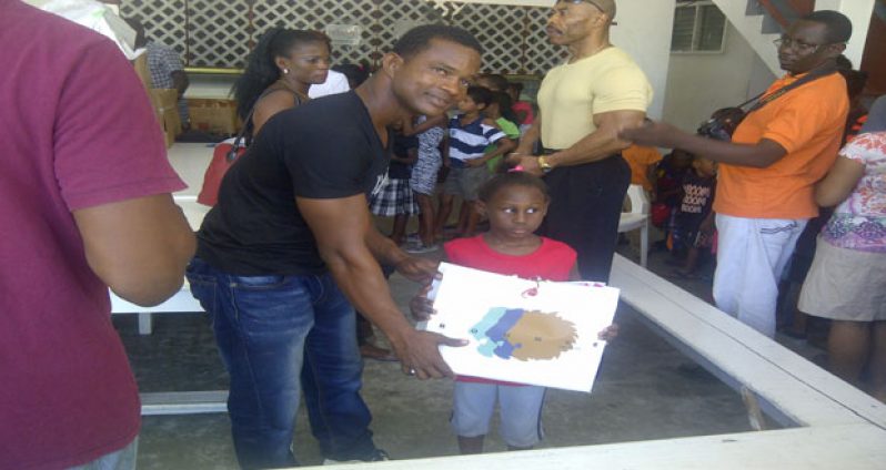 Fitness Ambassador Devon Davis presents a young lady with her Christmas gift