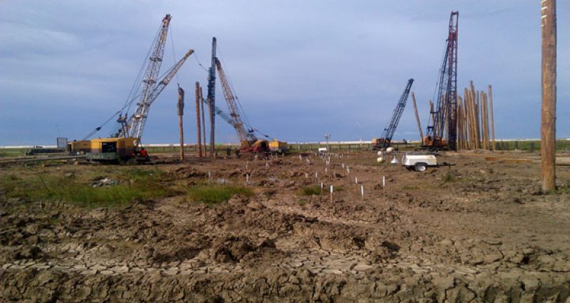 Four pieces of BK International’s machinery are engaged in the pile-driving exercise at the Movie Town construction site at Turkeyen, East Coast Demerara