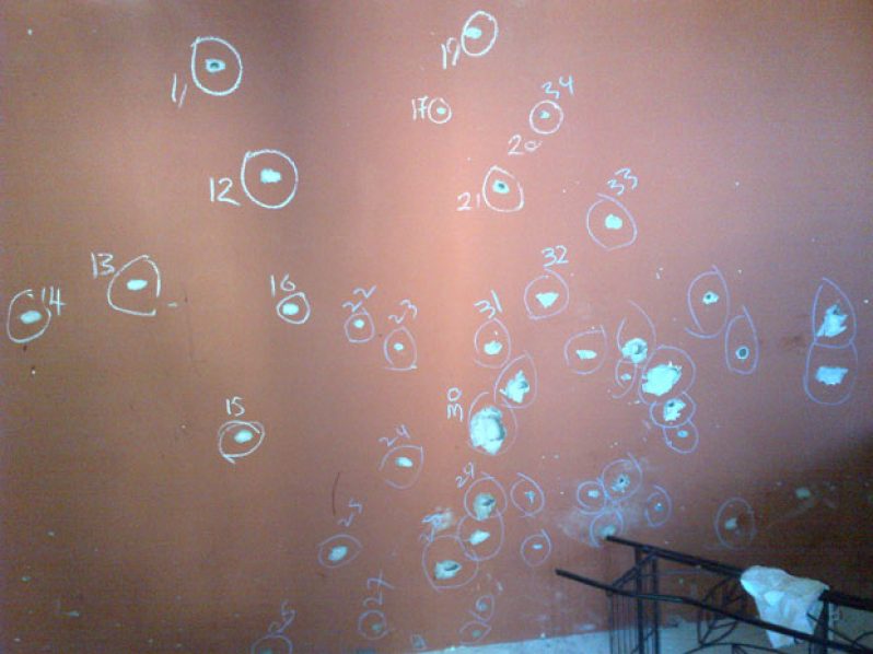The wall in the isolated room where the businessman fired his last shot, indicating the amount of bullets which penetrated the walls.