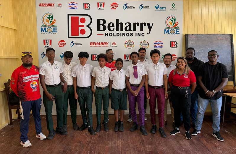 Students from the Essequibo schools with National U-19 Coach and First-Class spinner Antony Adams (right)