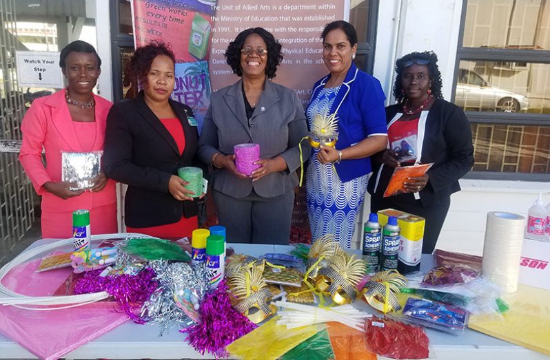 Administrator of the Allied Arts Unit, Ms. Lorraine Barker-King (centre) along with the teachers of the four schools at yesterday’s handing-over