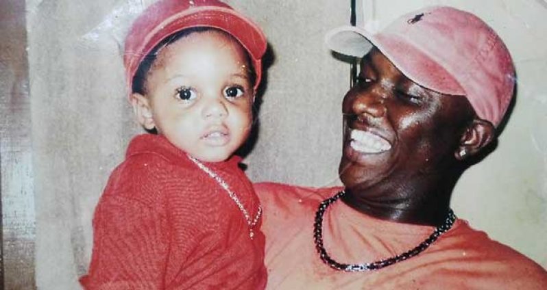 Orvin ‘Champo’ Millington with one of his four children