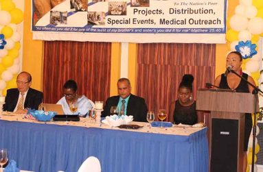 Ms. Rosanne Lee as she delivers the opening prayer at Food for the Poor’s 27th Anniversary Fund-raising Dinner at the Pegasus Hotel Guyana, last Saturday. Seated from left at head-table are: Food for the Poor’s Chairman, Mr. Paul Chan-a-Sue; Chief Medical Officer (ag), Dr. Karen Campbell); FFP’s Chief Executive Officer, Mr. Kent Vincent and Emcee, Ms. Tamika Henry.
