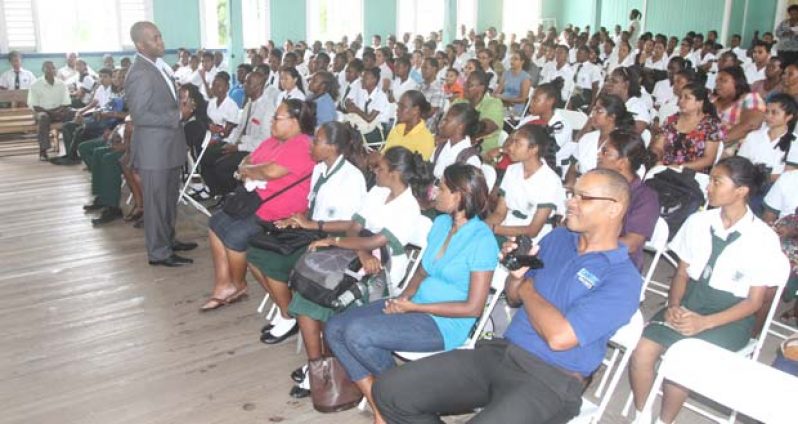 Astell Collins speaks to the gathering at St. Rose’s High