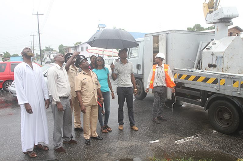 Assistant Commissioner, Clifton Hicken, senior police officers and members of faith-based organisations witness the erection of one of the lights