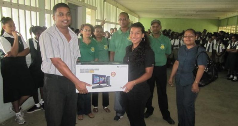 Members of the Executive Body of the ISTC/RISS Old Students Association - the interim secretary for the association, Salima Ali; the assistant secretary, Nandrani Persaud, and the treasurer, Sharon Dainty, who presented a computer to a teacher of Richard Ishmael Secondary School