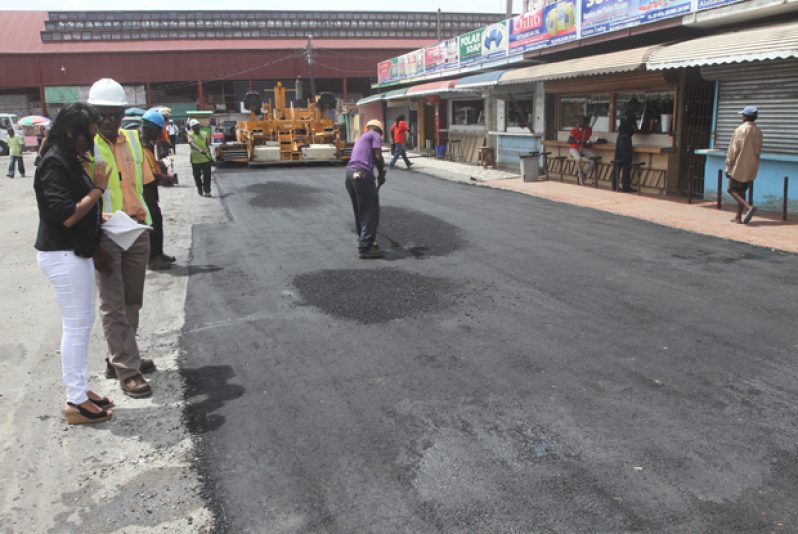 Lawrence Mentis, Force Account Unit Engineer (second left standing beside the journalist) on site, overseeing the progress of the work