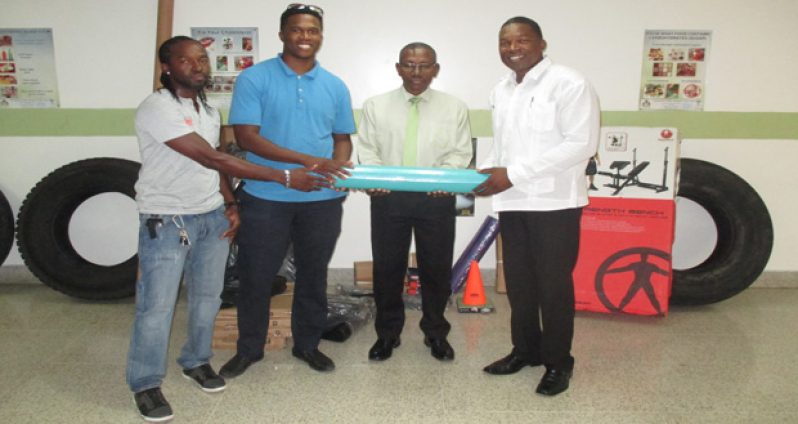 Cevon’s Maintenance Manager Kwesi Boston handing over the gym equipment to CEO of the GPHC, Allan Johnson
