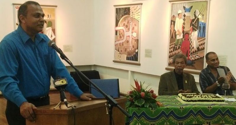 Minister of Culture, Dr Frank Anthony giving his address as Stanley Greaves listens in