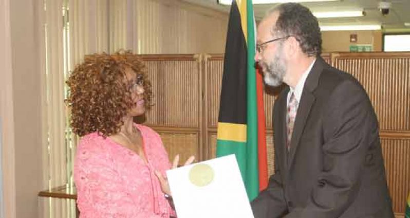 From left, South Africa’s plenipotentiary representative to CARICOM, Maureen Modiselle presents letters of credence to CARICOM Secretary-General, Ambassador Irwin LaRocque, yesterday (Sonell Nelson photo)