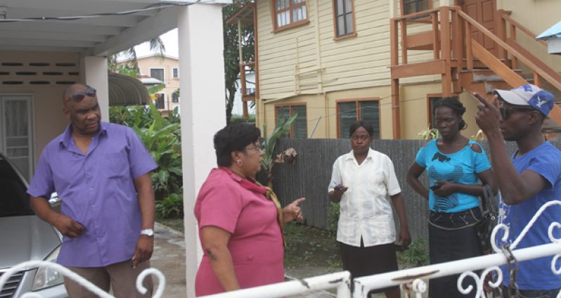 Acting Town Clerk Carol Sooba with security personnel at her residence yesterday morning