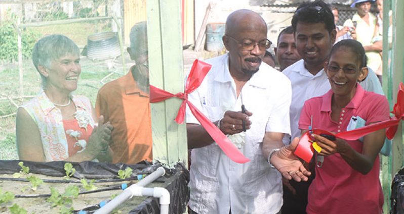 Local Government Minister, Norman Whittaker with beneficiary representative, Naiomi Rambarran cutting the ribbon with CARILED National Country Coordinator, Dhanraj Singh in the back and CARILED Programme Director, Alix Yule at far right