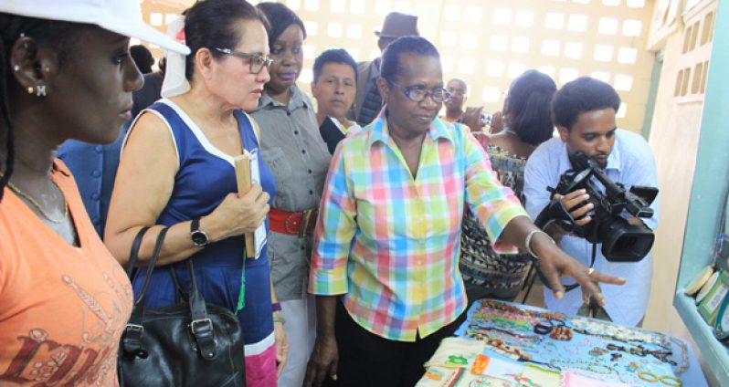 The First Lady  views exhibits at the exhibition held at the Christianburg Multilateral School yesterday