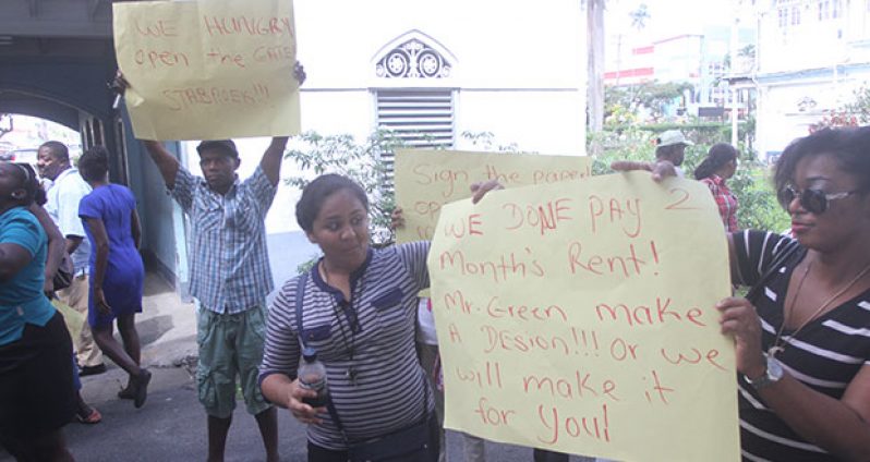 Protestors display their posters