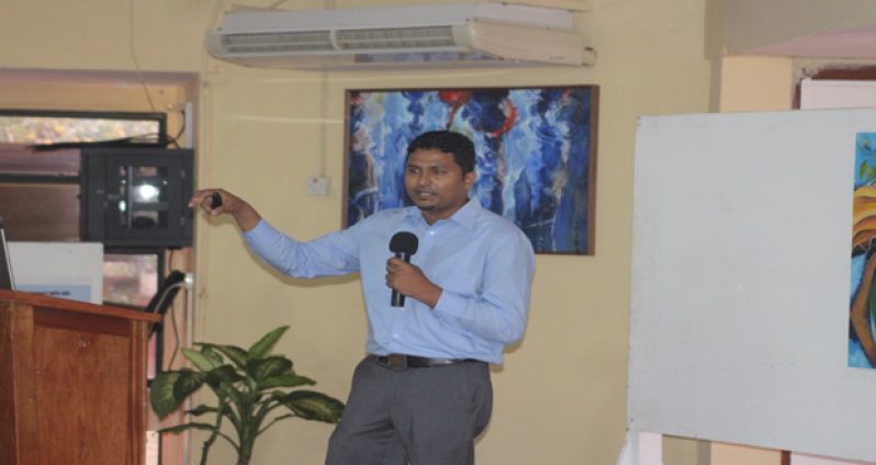 Department of Natural Resources and the environment employee Haimwant Persaud making a presentation on the use of Free and Open Source Software (FOSS) in building an enterprise