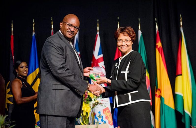 MoPT's Adviser on ICT, Lance Hinds, receives his award from CTU Secretary-General, Bernadette Lewis