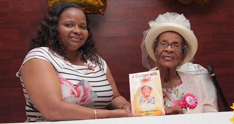 Minister of Social Protection, Volda Lawrence with ‘birthday girl’, Ms Helena Maude McAllister at the recent launch of her book, “A Century with Jesus”
