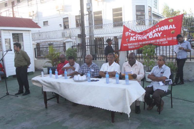 GAWU’s Aslim Ali chairs the Rally in GAWU compound, High Street, Kingston. Others seated from left are: Sherwood Clarke: Seepaul Narine;  Kenneth Joseph; Dr. Nanda Gopaul; Carvil  Duncan and Komal Chand, President of GAWU.