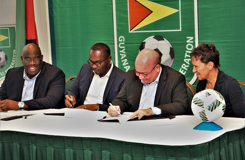 HISTORIC! Denmark Football Federation and its president Jesper Moller (second from right) and GFF president Wayne Forde (second from left) inking their MoU, while UEFA Head of International Relationship, Eva Pasquier, and CONCACAF’s Senior Project Officer, Howard McIntosh, look on. (Carl Crooker photo)