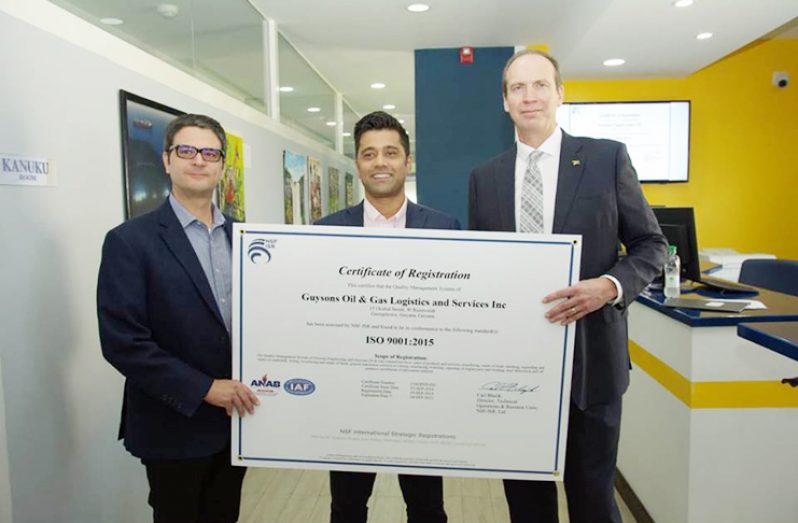 ExxonMobil’s CLBD Project Director, Patrick Henry; Guysons CEO Faizal Khan and ExxonMobil Guyana Operations Manager, Mike Ryan, holding a replica of the ISO 9001:2015 certificate. 
Samuel Maughn’ photo