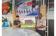 Manager of Regal Sports Store, Ian John hands over one of the televisions to a representative of Roraima Developers