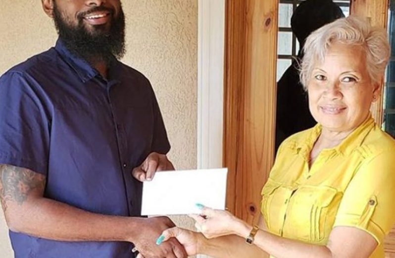 IBET representative Dustani Barrow hands over sponsorship to GMR&SC’s Cheryl Gonsales