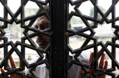 A man says a prayer from outside the window of the shrine of Bari Imam on the outskirts of Islamabad, Pakistan, April 27, 2015. REUTERS/Caren Firouz)