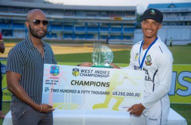 President Dr. Kishore Shallow presents the champion’s cheque to Guyana Harpy Eagles’ captain, Tevin Imlach.